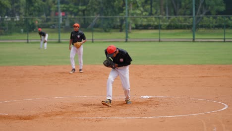 Panning-Shot-of-Softball-Player-Pitching-the-Ball