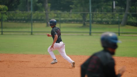 Panning-Shot-of-Softball-Player-Running-to-the-Base