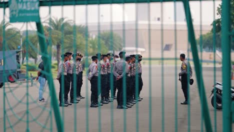 Wide-Shot-of-Indonesian-Servicemen-Behind-Fence