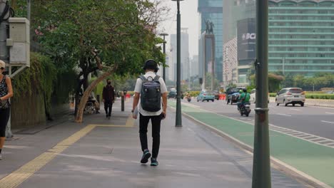 Tracking-Shot-Following-a-Person-Walking-Down-a-Street-In-Jakarta