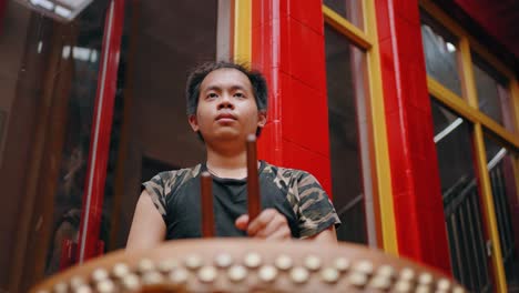 Low-Angle-Shot-of-Boy-Playing-Drum-in-Jakarta