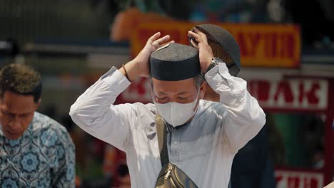Long-Shot-of-Man-Trying-on-Hat-in-Jakarta