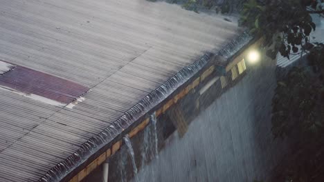 High-Angle-Shot-of-Rain-Pouring-Off-Sheet-Metal-Roof