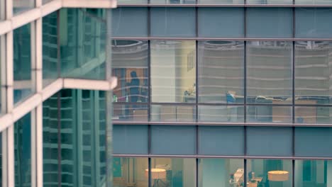 Long-Shot-of-Man-In-Office-Through-Skyscraper-Window