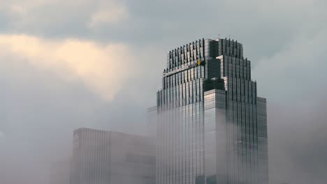Low-Angle-Shot-of-Clouds-Passing-Past-a-Skyscraper-01