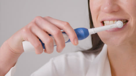 Close-Up-Shot-of-Woman-Brushing-Her-Teeth-and-Smiling