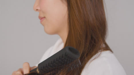 Close-Up-Side-Shot-of-Young-Woman-Brushing-Hair