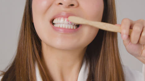 Tracking-Shot-of-Young-Woman-Brushing-Teeth