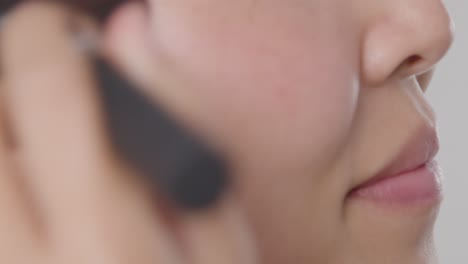 Close-Up-Shot-of-a-Young-Woman-Applying-Makeup