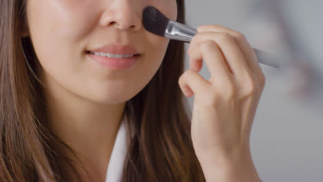 Close-Up-Shot-of-a-Woman-Applying-Foundation