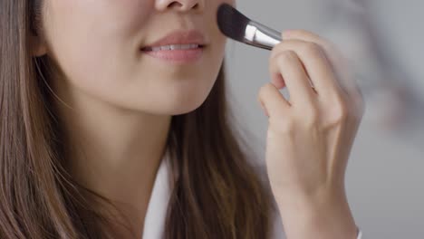 Close-Up-Shot-of-a-Woman-Applying-Foundation
