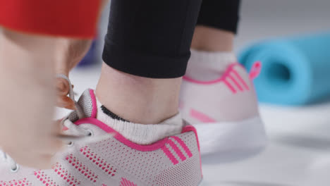 Close-Up-Shot-of-Girl-Putting-on-Gym-Shoes