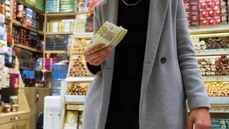 Mid-Shot-of-Man-Holding-His-Money