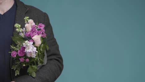 Mid-Shot-of-Man-Holding-Flowers-with-Copy-Space