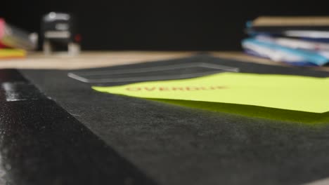 Tracking-Shot-Over-Stamp-on-Sticky-Note