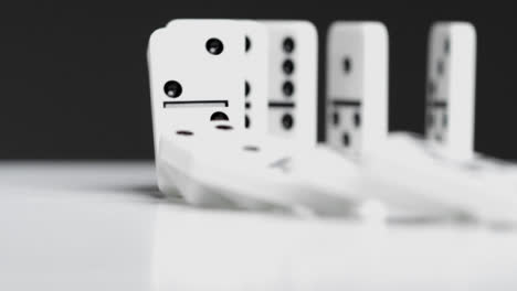Close-Up-of-Dominoes-Falling-Over