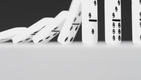 Low-Angle-Shot-of-Dominoes-Falling-Over