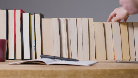 Tracking-Shot-of-Man-at-Desk-with-Books-02