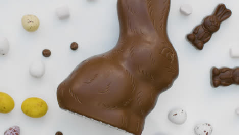 Top-Down-Shot-of-Rotating-Chocolate-Easter-Bunny-and-Eggs