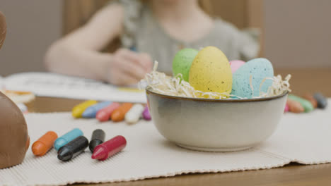 Tracking-Shot-of-Easter-Decorations-and-a-Child-Drawing