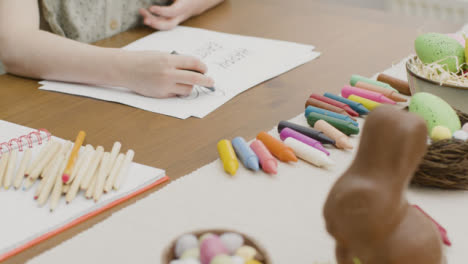 Tracking-Shot-of-a-Young-Child-Colouring-Easter-Themed-Drawing