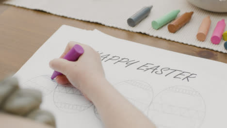 Tracking-Shot-of-Young-Girl-Colouring-In-an-Easter-Themed-Drawing
