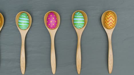 Tracking-Shot-of-Easter-Eggs-In-Wooden-Spoons-with-Copy-Space