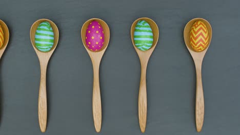 Tracking-Shot-of-Colourful-Easter-Eggs-In-Wooden-Spoons-with-Copy-Space