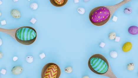 Ascending-Top-Down-Shot-of-Rotating-Easter-Eggs-In-Wooden-Spoons-with-Confectionary