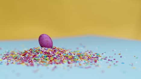Close-Up-Shot-of-Rotating-Hundreds-and-Thousands-with-Small-Chocolate-Egg