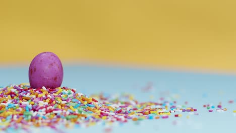 Extreme-Close-Up-Shot-of-Rotating-Hundreds-and-Thousands-with-Small-Chocolate-Egg