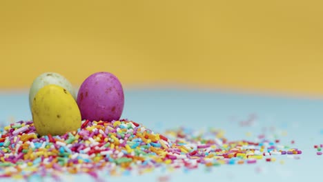 Extreme-Close-Up-Shot-of-Rotating-Hundreds-and-Thousands-with-Small-Chocolate-Eggs