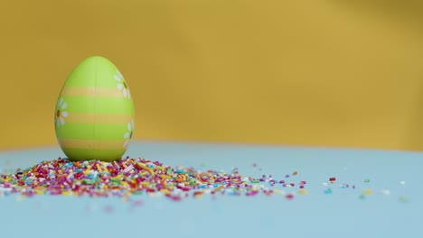 Close-Up-Shot-of-Rotating-Hundreds-and-Thousands-with-Easter-Eggs