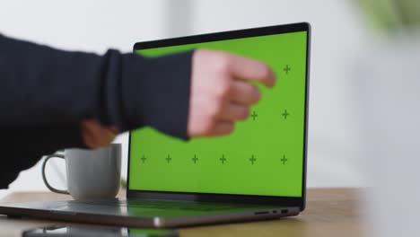Sliding-Shot-of-Brand-New-MacBook-Pro-On-Desk-with-Green-Screen-04