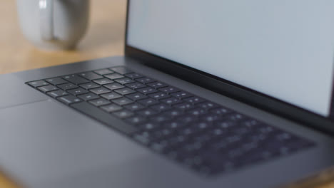 Sliding-Shot-of-Brand-New-Apple-MacBook-Pro-On-Desk-10