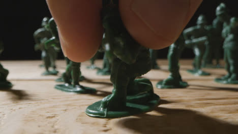 Tracking-Shot-of-Toy-Soldier-Being-Placed-Dowm