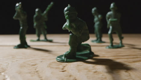 Tracking-Shot-Pulling-Away-from-Handful-of-Toy-Soldiers