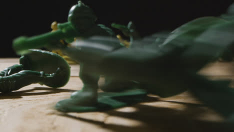 Tracking-Shot-of-Toy-Soldiers-Being-Knocked-Down