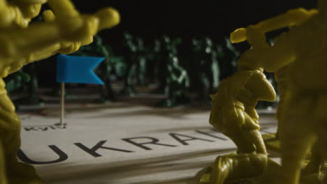 Tracking-Shot-Over-Toy-Soldiers-On-Map-of-Ukraine-with-Flashing-Lights-05