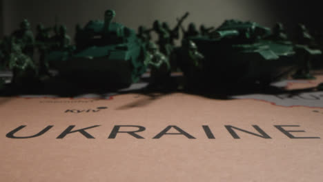 Tracking-Shot-of-Toy-Soldiers-On-Map-of-Ukraine-with-Flashing-Lights