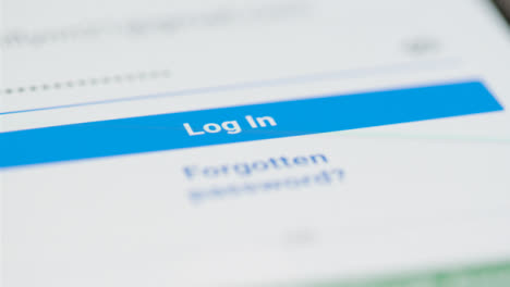 Close-Up-Tracking-Shot-of-Facebook-Login-Button-on-Phone