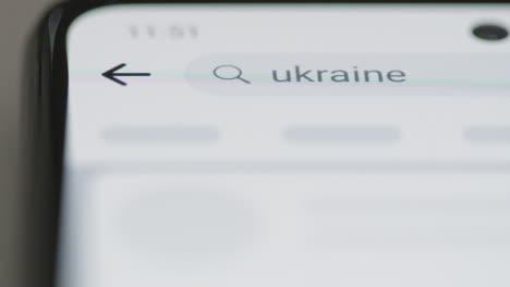 Tracking-Close-Up-Typing-Ukraine-in-Facebook-Search-Bar-on-Phone