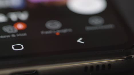 Close-Up-Tracking-Shot-of-Netflix-Menu-Icons-on-Phone