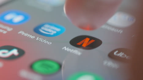 Tracking-Close-Up-to-and-Opening-Netflix-on-Mobile-Phone