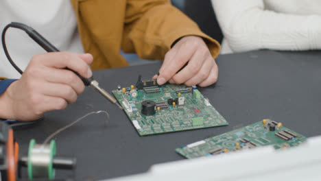 Close-Up-Shot-of-Engineering-Student-Soldering-Circuit-Board-01