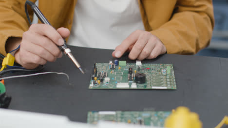 Close-Up-Shot-of-Engineering-Student-Soldering-Circuit-Board-02