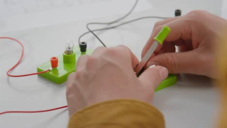 Close-Up-Shot-of-Engineering-Student-Building-Electrical-Circuit-14