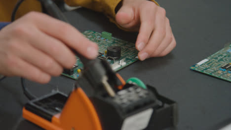 Close-Up-Shot-of-Engineering-Student-Soldering-Circuit-Board-03