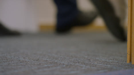 Close-Up-Shot-of-Students-Feet-Walking-Down-Corridor
