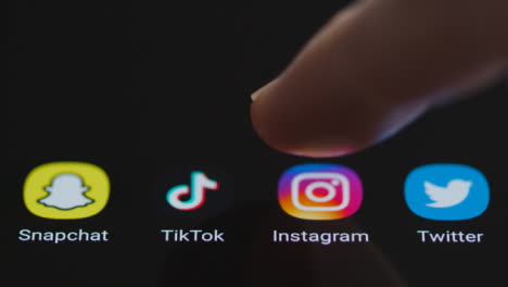 Close-Up-Shot-of-Finger-Tapping-Instagram-On-Smartphone-Screen